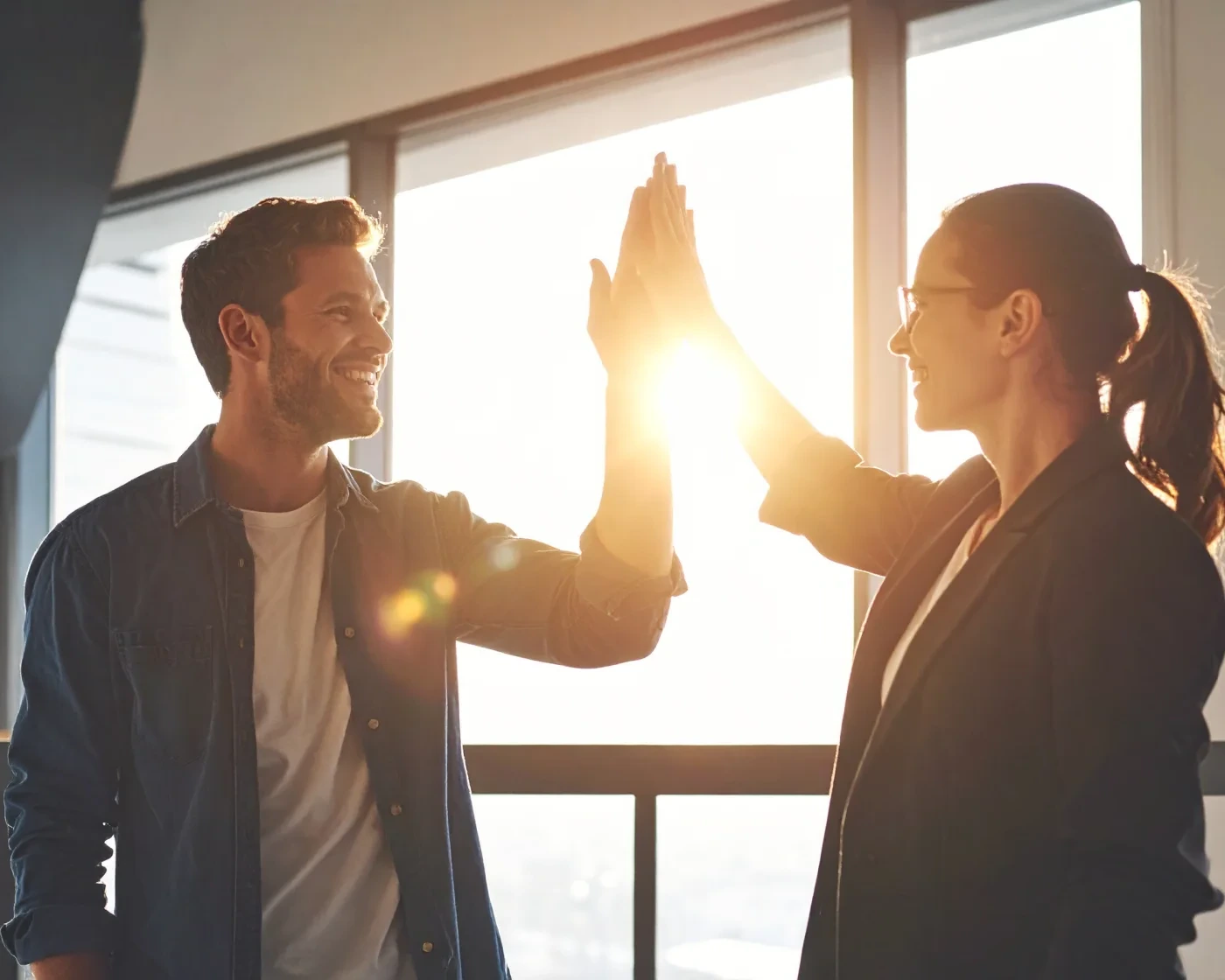 Two professionals celebrating progress in a workplace development program